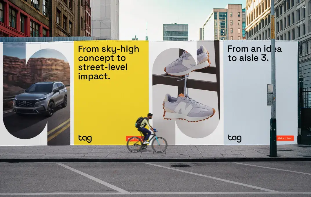 A cyclist passes by a city street billboard with ads featuring a car, sneakers, and text about concepts and ideas.